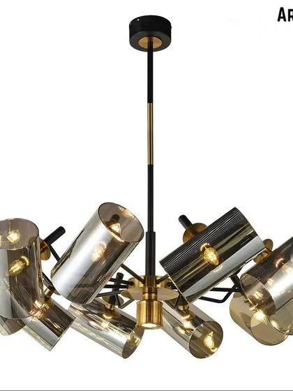 A modern chandelier with angled, smoky glass shades. The dynamic arrangement of the lights adds a sense of energy and style, perfect for a contemporary dining room or foyer.