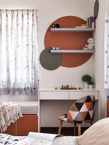 A sneak peek of a kids' room designed for twins, avoiding the typical blue and pink. The design uses a sophisticated palette of terracotta and grey, with geometric patterns and a cozy window seat.