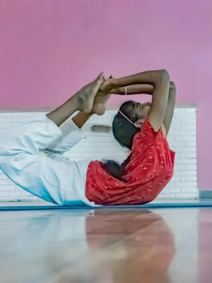 With dedicated practice, children can develop remarkable flexibility and focus. This student demonstrates an advanced variation of Dhanurasana, the Bow Pose, showcasing the strength and discipline cultivated in our classes.