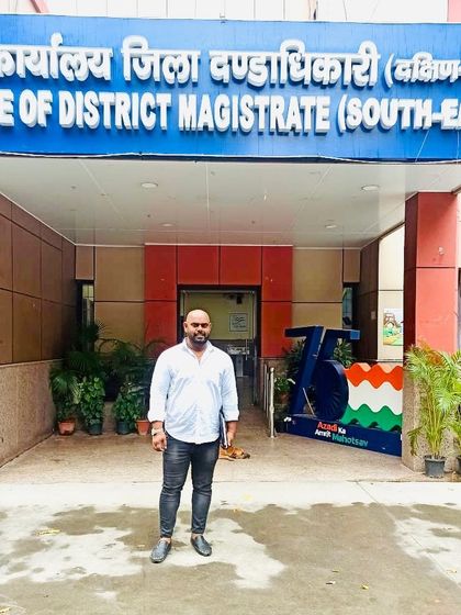 At the office of the District Magistrate (South-East), handling official work.