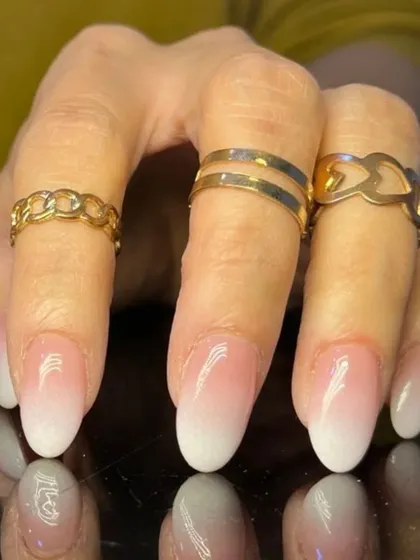 A close-up of a perfect baby boomer ombre, showing the soft gradient on well-manicured nails.