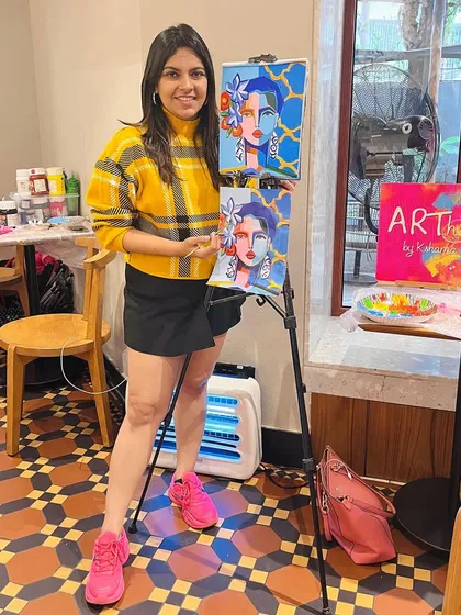 Me standing by my demonstration canvas at a cafe workshop. I paint along with the participants to guide them through every step.