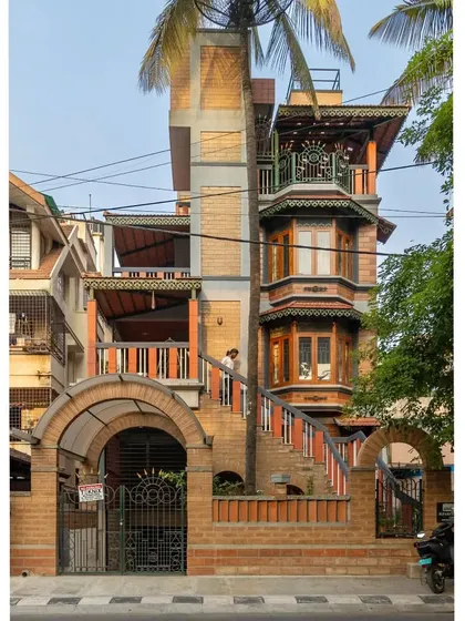 This home in Basavanagudi, Bangalore, is a testament to our belief in complex, layered design that feels organic and rooted. We integrated exposed earth blocks, traditional bay windows, and multiple balconies, even allowing a palm tree to grow through the structure, truly merging the building with its landscape.