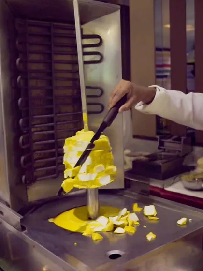 A unique live station featuring Paneer Shawarma, where a large block of seasoned paneer is shaved just like traditional meat shawarma, offering a vegetarian twist on the Middle Eastern classic.