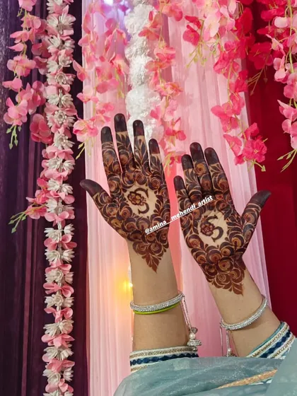 A simple yet beautiful design focusing on the palms, with a central circular motif containing the 'Om' symbol.