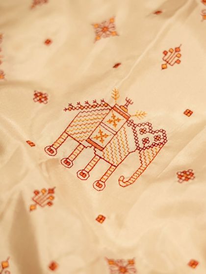 A detailed shot of the Kasuthi embroidered elephant motif, showcasing the precision and skill required for this traditional art form.