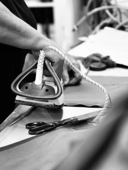 The final press. This is a crucial step in the tailoring process, ensuring that every seam is flat, every line is crisp, and the garment drapes perfectly.