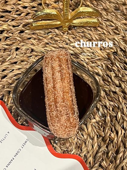 A classic churro, perfectly fried and dusted with cinnamon sugar, served with a rich dark chocolate dipping sauce.