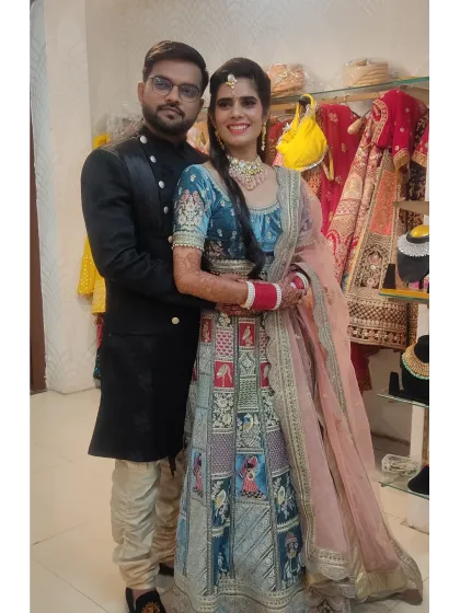 Here’s how I help couples create a perfectly coordinated look. This bride’s unique Doli Barat lehenga pairs beautifully with the groom's classic black bandhgala sherwani.