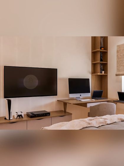 This bedroom combines work, entertainment, and rest. The custom cabinetry includes a TV unit and a connected work desk, demonstrating how we create multi-functional furniture solutions tailored to our clients' needs.