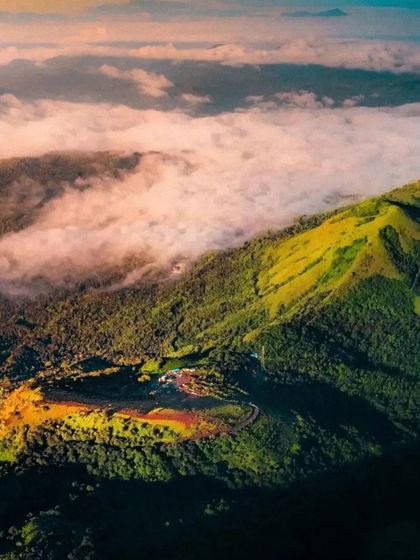 An aerial view of the Baba Budangiri hills, showing the vibrant colors of the landscape.