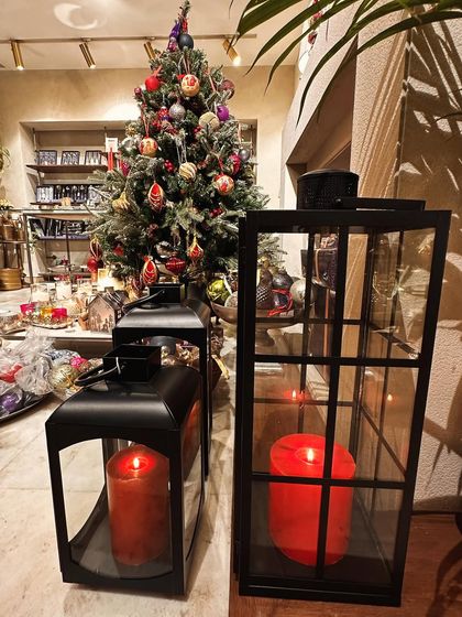 These black metal lanterns with red candles are a classic Christmas decor item, perfect for placing by the fireplace or on the porch.