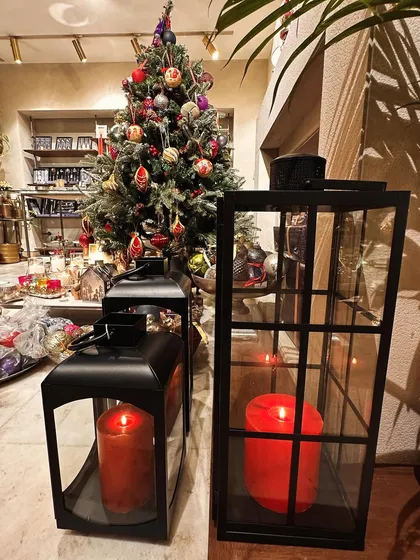 A view of my store during Christmas, with the black lanterns standing next to the tree. Their classic design makes them suitable for any festive occasion, from Christmas to a wedding reception.