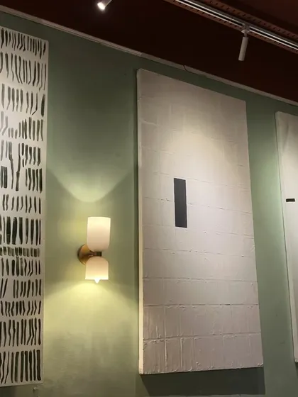 A set of three large 6ft x 3ft minimalist abstract paintings installed at Sidewalk cafe. The black and white theme is modern, graphic, and very chic.