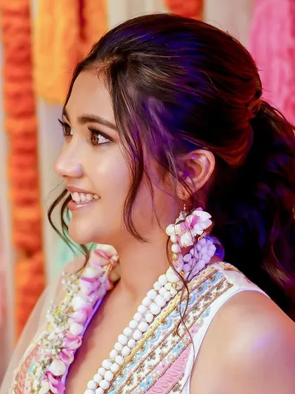 A close-up of this bride's fresh and natural Haldi makeup. The focus is on creating luminous skin that glows from within, paired with a soft pink lip.