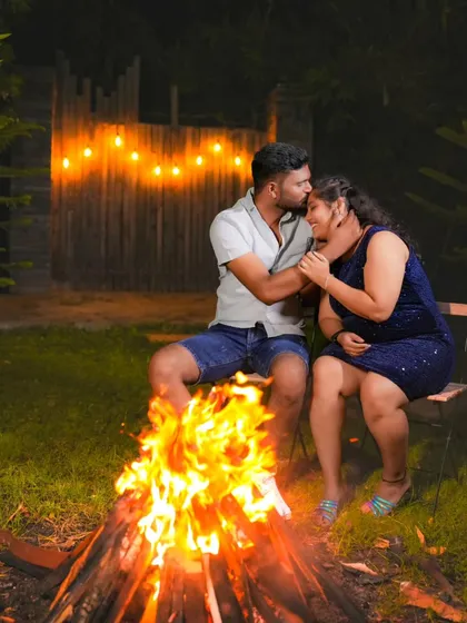 A tender forehead kiss by the warm glow of the bonfire. These are the unscripted, beautiful moments I love to capture.