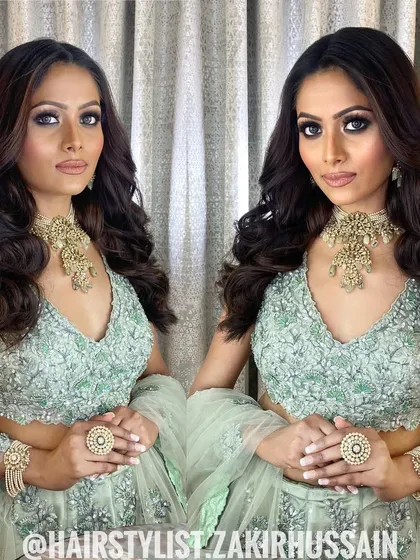 A mirrored image of the client with her soft waves, showing the symmetry and beauty of the style.