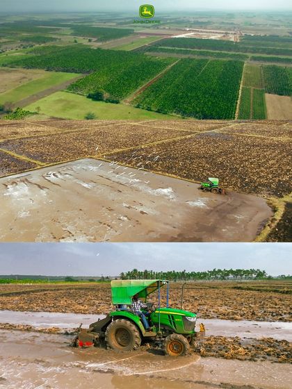 A John Deere tractor at work in the fields. Our aerial and ground footage captures agricultural machinery in action, perfect for promotional content.