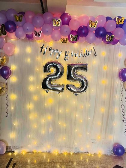 Another view of the 25th birthday setup with the fairy light wall. The purple and pink balloons create a beautiful frame for photos.