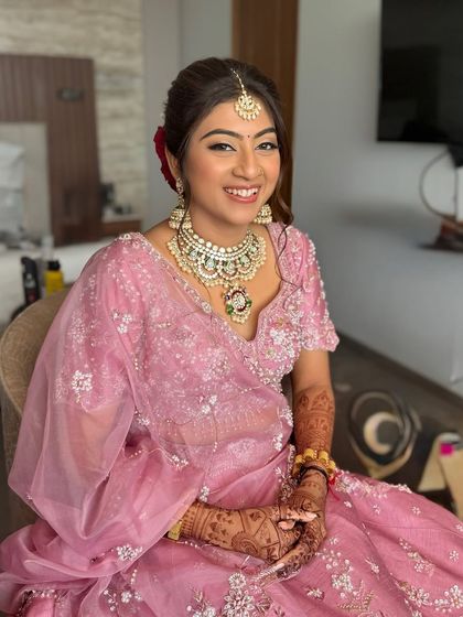 A happy portrait of my pastel princess. Her soft pink lehenga is paired with a luminous makeup look, featuring a flawless base, soft-smoky eyes, and a matching pink lip.