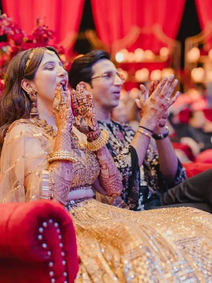 The couple cheering on the performances, fully immersed in the celebration we've curated for them.