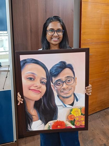 Me with a framed portrait that turned a client's selfie into a work of art.