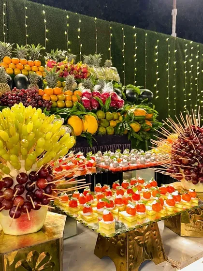 My Exotic Fruit Display is a feast for the eyes and the palate. I create a vibrant, multi-level counter with an abundance of fresh, hand-cut tropical fruits like pineapple, grapes, and mango, offering a healthy and beautiful dessert option.