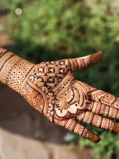 A beautiful geometric design on the back of the hand. The interlocking squares and fine lines create a pattern that is both modern and intricate.