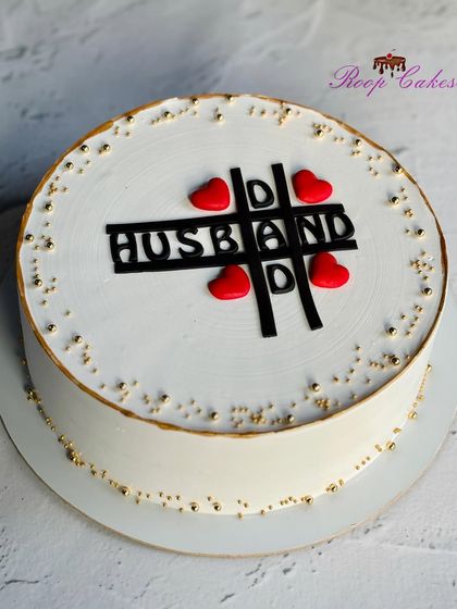 A simple yet beautiful cake for a husband, featuring a playful tic-tac-toe design with hearts.
