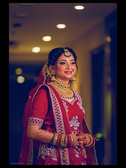 The bride looks radiant and happy, ready for her North Indian wedding ceremony.