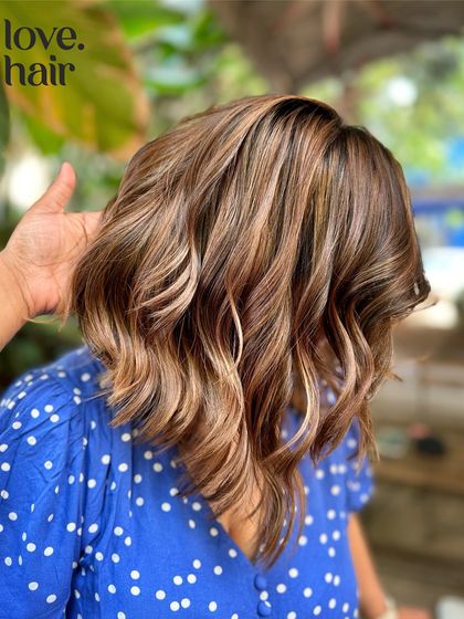 A close-up shot of the 'iced caramel macchiato' balayage, highlighting the beautiful blend of warm caramel and cool brown tones.
