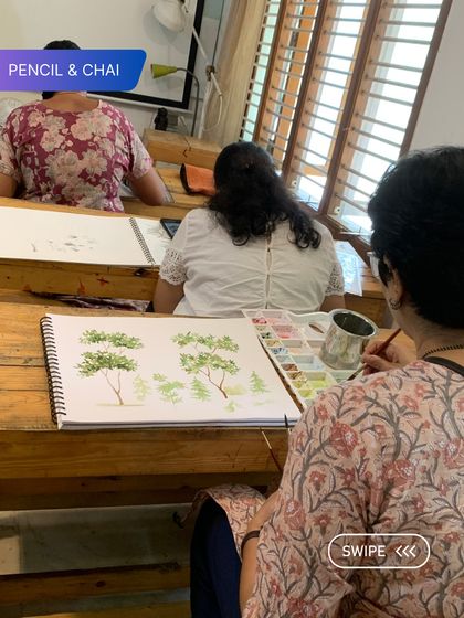 A view from behind shows our adult learners deep in their practice. The shared silence is filled with the sound of brushes on paper, a testament to the collective focus in the room.