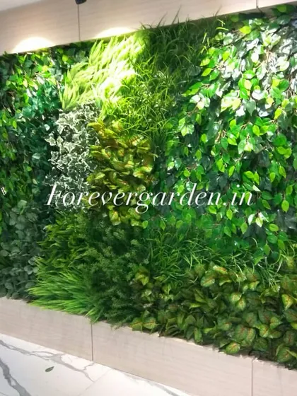 A wide, panoramic green wall installation in a brightly lit corridor, featuring a dynamic mix of textures and colors.