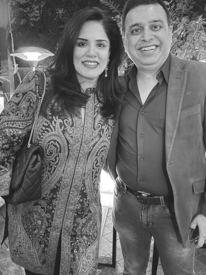 A black and white photo with my husband. I'm wearing a paisley print tunic, a classic pattern that always looks chic.