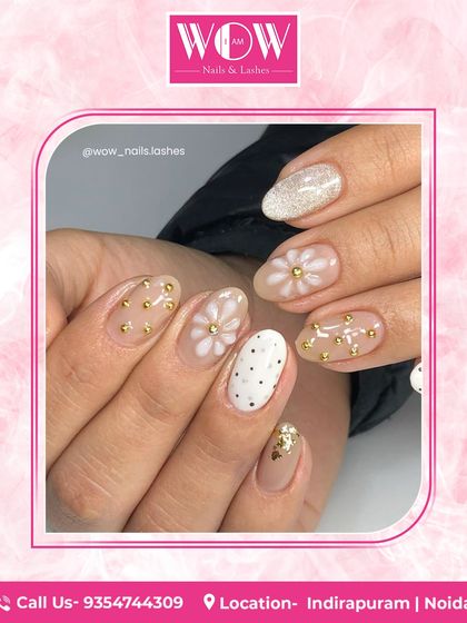 A cute and whimsical design featuring a neutral base with hand-painted daisies, polka dots, and gold foil accents. This look is playful and chic.