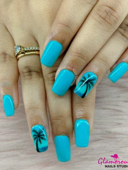 Get those vacation vibes right on your fingertips. We created this tropical look with a bright turquoise blue base and hand-painted palm tree silhouettes for a perfect beach-ready manicure.