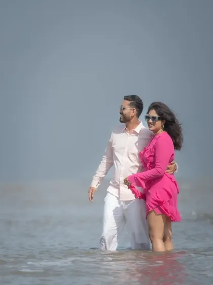 A romantic moment in the water during a pre-wedding beach session. The soft, hazy light gives this portrait a dreamy and ethereal quality.