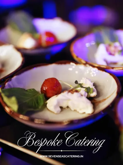 Bespoke Catering at its finest. A deconstructed caprese salad with cherry tomato, fresh basil, and creamy mozzarella, presented as individual, artful components.