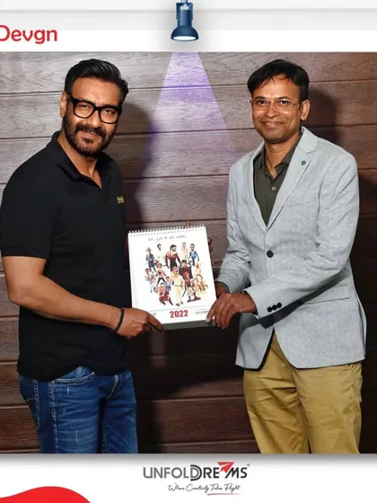 With actor Ajay Devgn, presenting him with a copy of my star calendar.