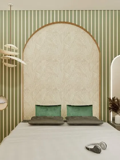 This bedroom is a sanctuary of calm, blending muted greens with natural wood and cane textures. The arched accent wall behind the bed creates a soft, inviting focal point, while the perforated wardrobe doors and layered lighting add depth and warmth. It’s a minimalist design that is rich in detail, perfect for unwinding after a long day.