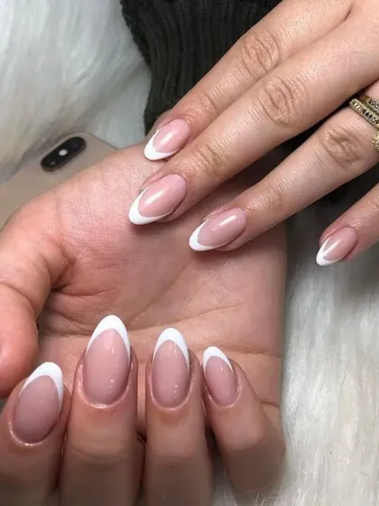 A classic French manicure on beautifully shaped almond nails, perfect for a sophisticated and timeless style.