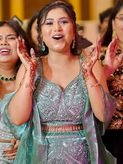 Pure joy and excitement. This candid shot captures the fun of the party, with her makeup looking flawless.