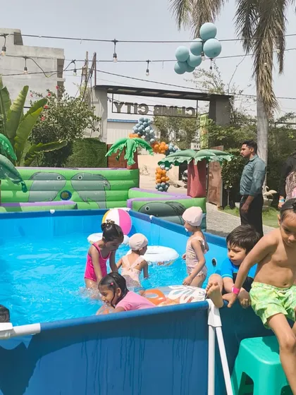 Kids cooling off and having fun in our large frame pool during a sunny day party.