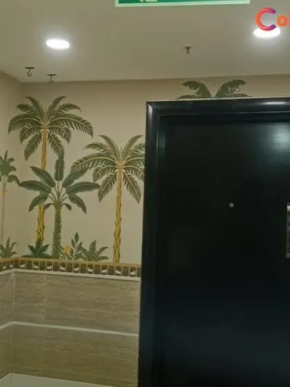Bring traditional Indian art into your home with a custom wallpaper. This design, inspired by Pichwai art with its distinct cow and palm tree motifs, creates a warm and culturally rich welcome in this entryway.