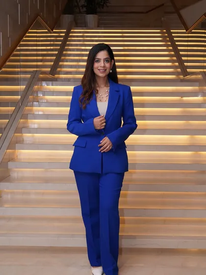 A full-length view of my blue power suit against a beautifully lit staircase.