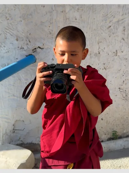 A young monk in Ladakh gets his hands on my camera. It's a beautiful moment, perhaps sparking the passion for photography in the next generation. Happy World Photography Day!