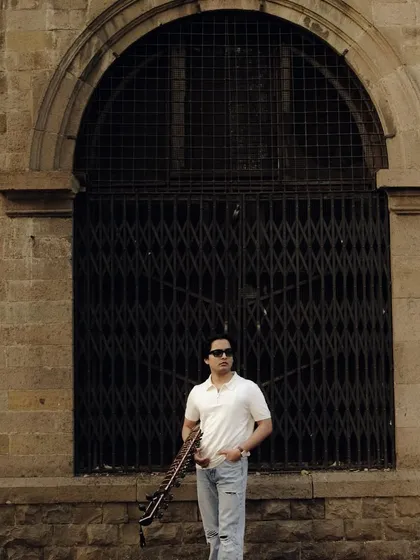 A candid photo from a shoot in Mumbai. The architecture of the city provides a beautiful contrast to the traditional form of the sitar.