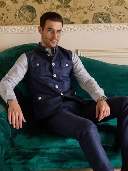 A relaxed yet refined look featuring the Hunter Style Waistcoat. The midnight blue linen and contrasting white buttons create a sharp, modern aesthetic.