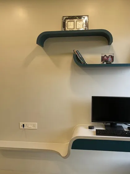 A close-up of the custom-designed floating desk and shelves, a perfect space-saving solution for homework and hobbies.