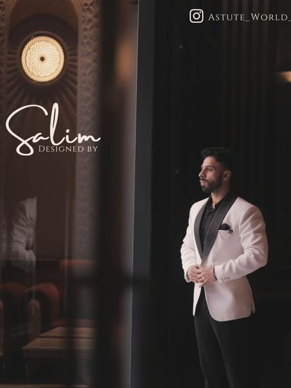 A contemplative shot of a client in a white tuxedo jacket. The quality of the tailoring ensures a perfect silhouette from every angle.